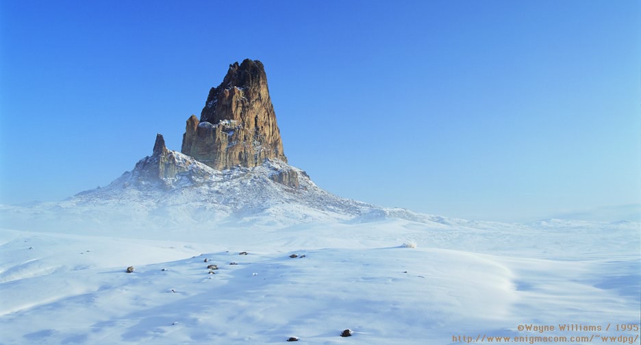 Photo of a rock sticking out of a snow