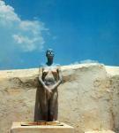 Girl with assimilative coloration as rock and sky