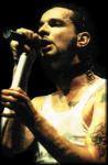 Photo by Dave Gahan, in a white shirt with tattoos